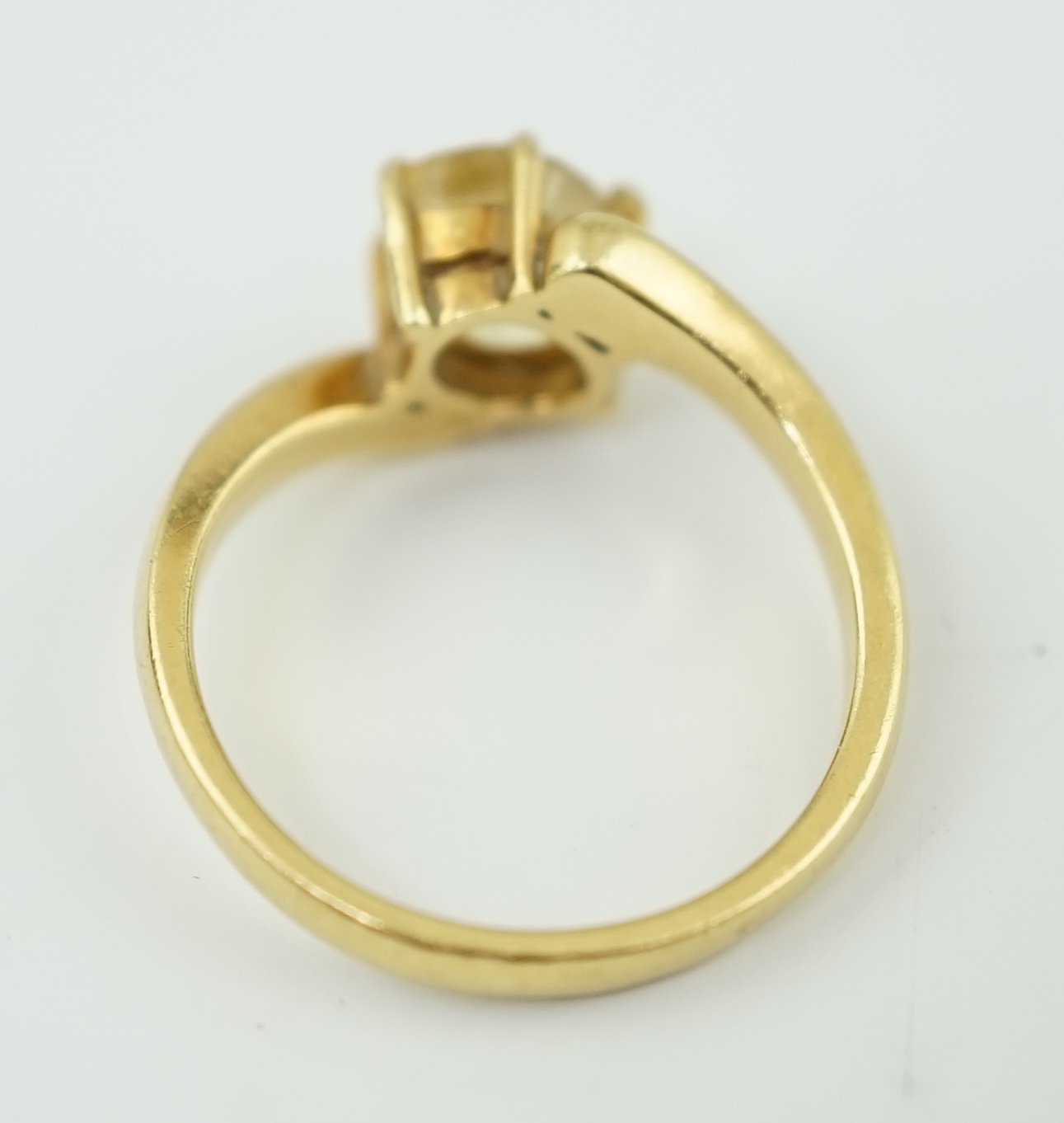 An 18k gold and solitaire oval cut yellow sapphire